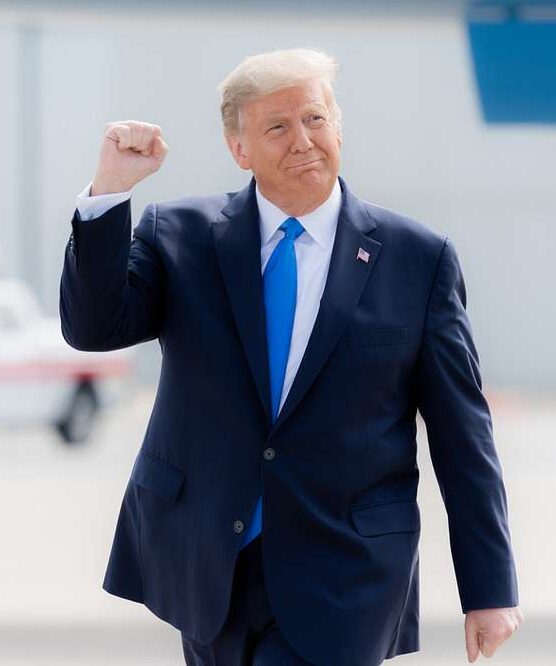 Trump, Weariing a Blue Suit and Tie, Pumps His Fist