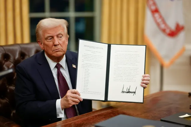 Trump Proudly Holds Up an Executive Order He Signed